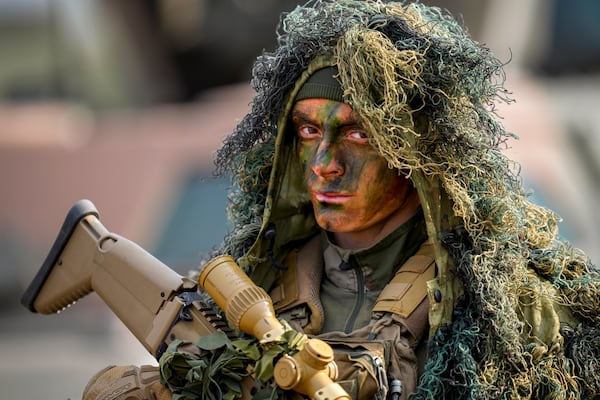 A French paratrooper stands at the end of the Steadfast Dart 2025 exercise, involving some 10,000 troops in three different countries from nine nations and represent the largest NATO operation planned this year, at a training range in Smardan, eastern Romania, Wednesday, Feb. 19, 2025. (AP Photo/Vadim Ghirda)