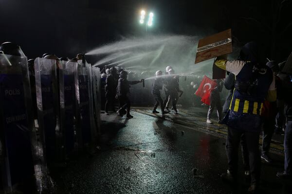 Riot police officers use pepper spray to clear protesters during a protest after Istanbul's Mayor Ekrem Imamoglu was arrested and sent to prison, in Istanbul, Turkey, Sunday, March 23, 2025. (AP Photo/Huseyin Aldemir)