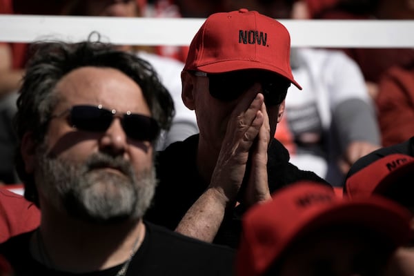 People attend a public memorial ceremony for slain hostage Tsachi Idan, a fan of Hapoel Tel Aviv F.C., who was killed in Hamas captivity in the Gaza Strip, at Bloomfield Stadium in Tel Aviv, Israel, Friday, Feb. 28, 2025. (AP Photo/Leo Correa)