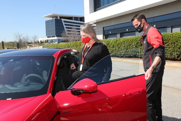 Atlanta, GA - 03-08-21 Porsche instructor Chris Ivester (R) speaks to reporter Mary Welch at the Porsche Experience Center Atlanta on International Women's Day. (Tyson Horne / tyson.horne@ajc.com)