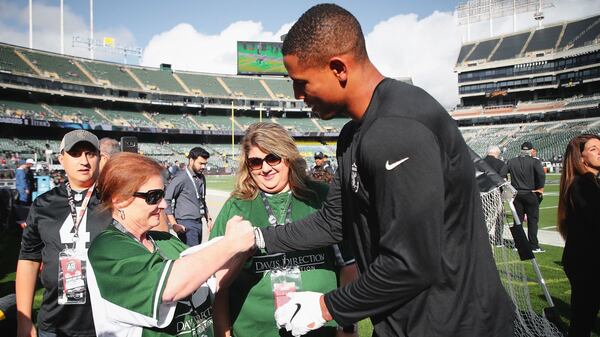 Prior to Sunday's game with Tennessee, Darren Waller is presented a wrist band supporting the Marietta-based drug awareness organization, the Davis Direction Foundation. The foundation founder, Missy Owen, is doing the honors. (Photo courtesy Darren Waller)