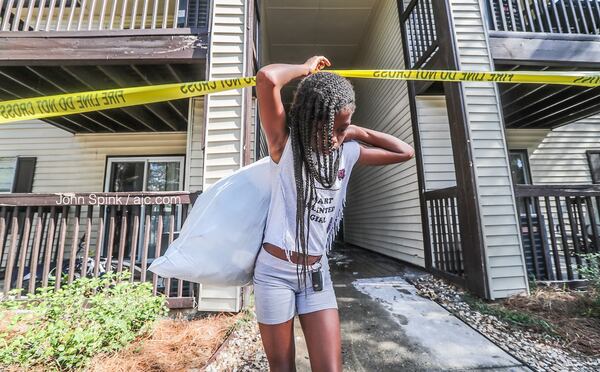 Jaziyah Warthen, 10, brings out her belongings after she, her three siblings, her mother and her aunt were displaced from their Union City apartment. A fire Thursday evening destroyed their unit.