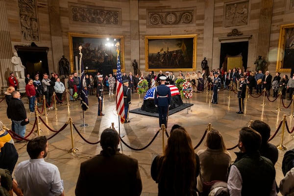 Mourners pay tribute to former President Jimmy Carter inside the Capitol Rotunda in Washington on Tuesday. Carter, 100, died Dec. 29.