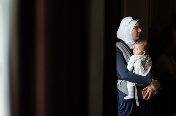 Hiba Tinawi, from Syria, holds her 6-month-old daughter Judy during an event to welcome Syrian refugee families who have recently resettled in the city of Clarkston, Saturday, Dec. 12, 2015, Clarkston, Ga. BRANDEN CAMP/SPECIAL