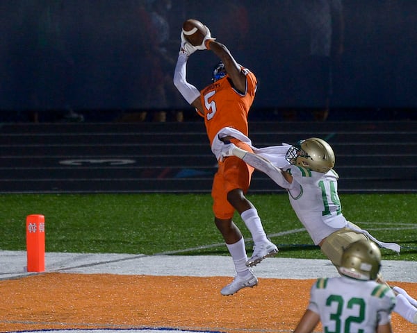 North Cobb wide receiver Christian Moss (5) hauls in a pass against Buford defensive back Jake Pope (14) for a touchdown in the first half Sept 11, 2020, in Kennesaw. (Daniel Varnado/For the AJC)