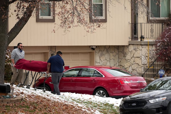 Workers carry a body from the home of former Kansas City, Kan. police detective Roger Golubski on Monday, Dec. 2, 2024, in Edwardsville, Kan. (AP Photo/Charlie Riedel)