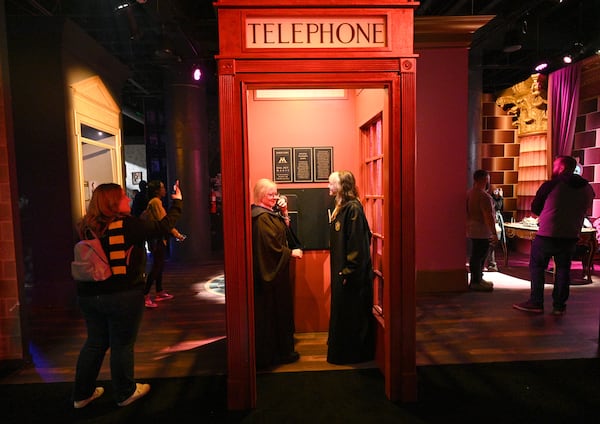 Harry Potter fans Jessica Simon (center left) and her daughter Sunshine Patterson enjoy authentic props, costumes, and interactive technology at “Harry Potter: The Exhibition” at 200 Peachtree in downtown Atlanta on Friday, October 21, 2022. (Hyosub Shin / Hyosub.Shin@ajc.com)