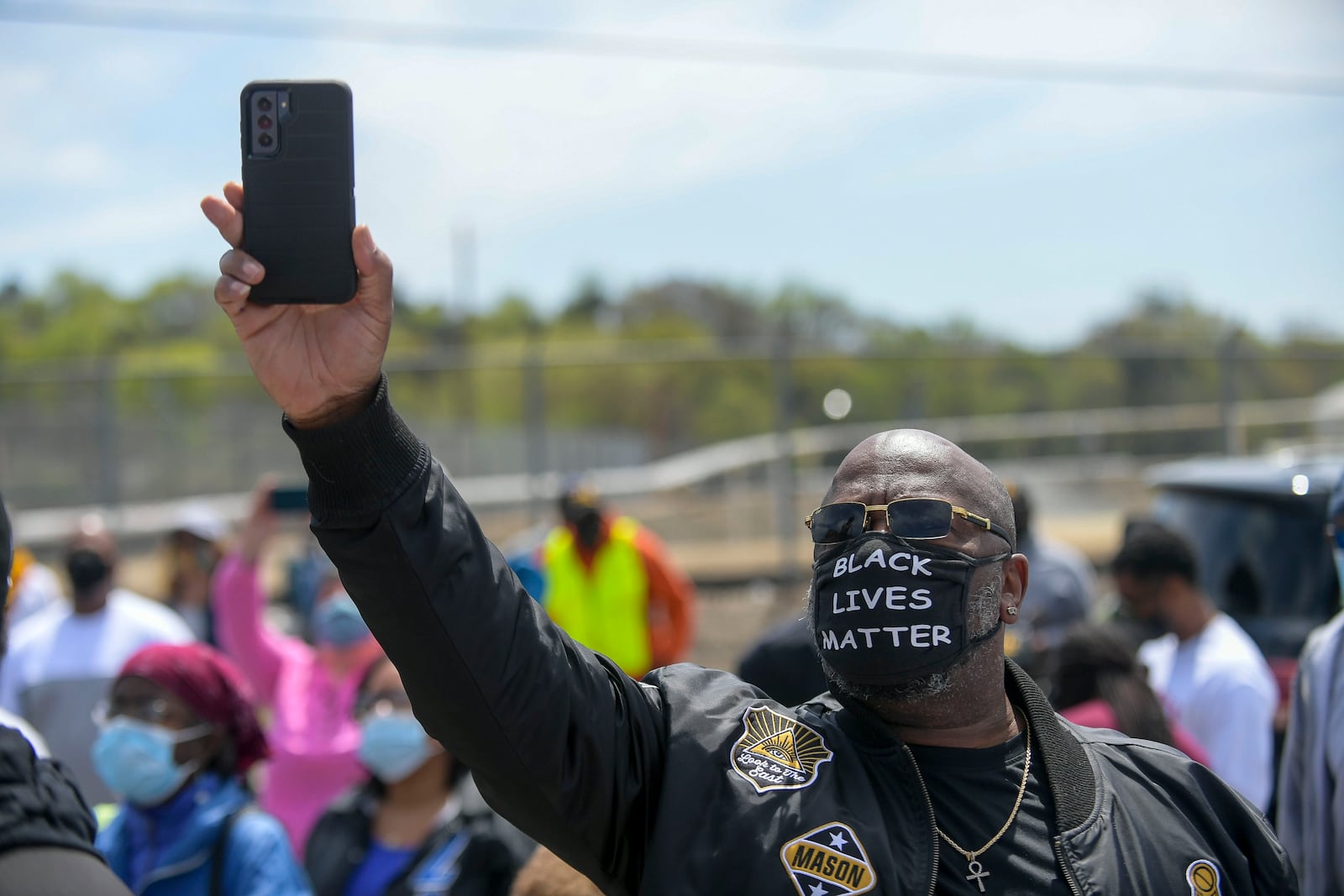 Marietta resident Rodney Harris takes a photo at the site of the former Chattahoochee Brick Company during a sacred event to commemorate the lives lost during the period the company used the convict lease system. The event included a procession, prayers, libations, community testimonials and site consecration Saturday, April 3, 2021, in Atlanta. (Photo: Daniel Varnado for The Atlanta Journal-Constitution)