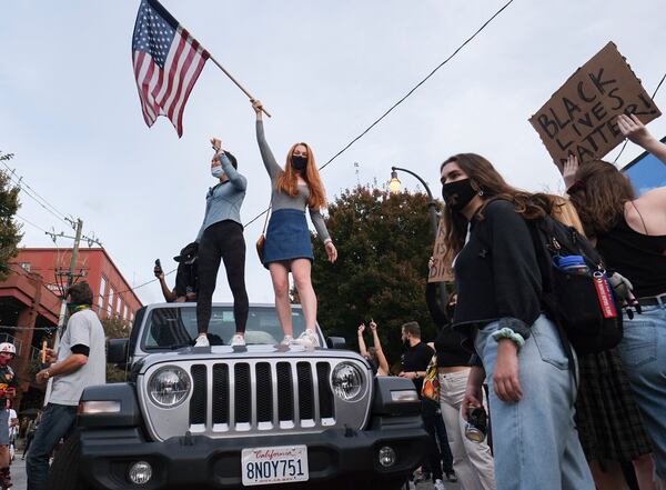 11/7/20 - Atlanta, GA - People cheer after the election was called for Joe Biden as they gathered in Midtown Atlanta to celebrate.   Ben Gray for the Atlanta Journal Constitution