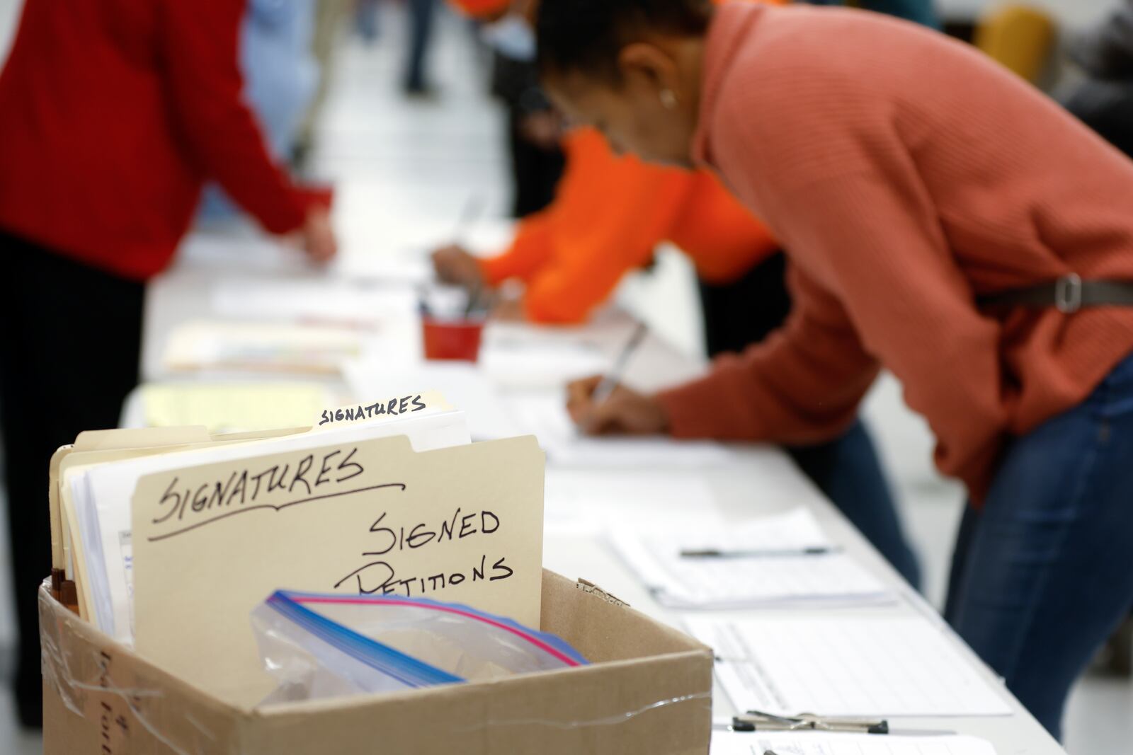 Members of the Mableton community sign petitions following the town hall discussion about the process to de-annex from the city on Wednesday, January 18, 2023.  (Natrice Miller/natrice.miller@ajc.com) 