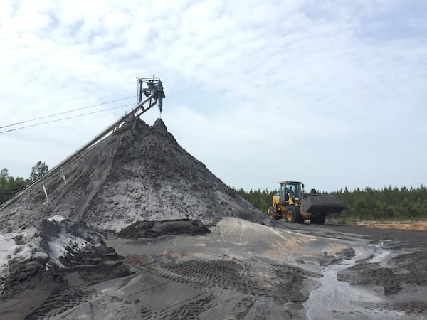 Minerals containing rare-earth elements are just one of the products being mined by Southern Ionics as it digs up ancient beach sand in South Georgia. Most of the attention is on darker-colored minerals found in the deposits. Photo courtesy of Southern Ionics.