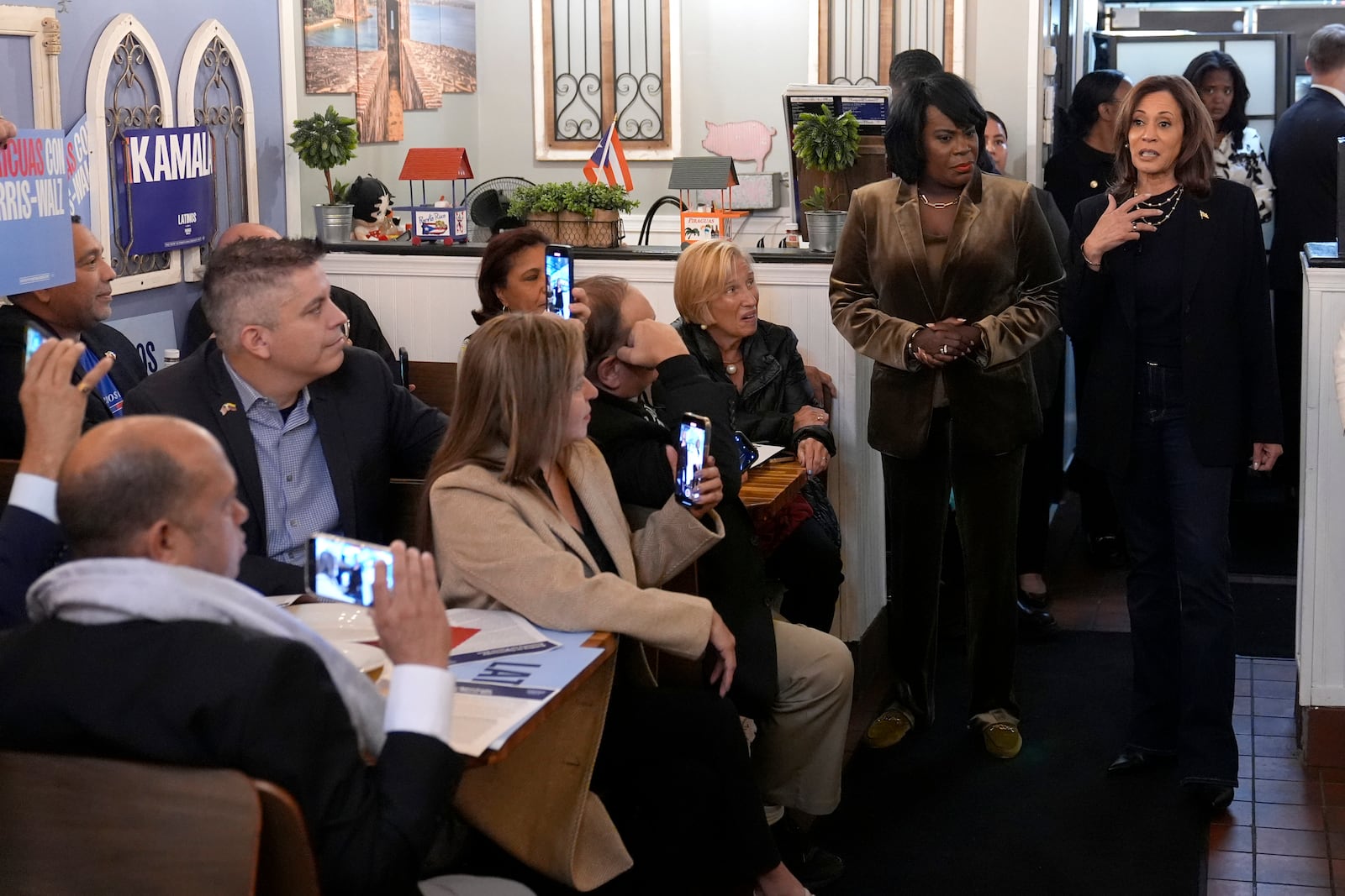 Democratic presidential nominee Vice President Kamala Harris, from right, speaks alongside Philadelphia Mayor Cherelle Parker at Freddy and Tony's restaurant during a campaign stop, Sunday, Oct. 27, 2024, in Philadelphia. (AP Photo/Susan Walsh)