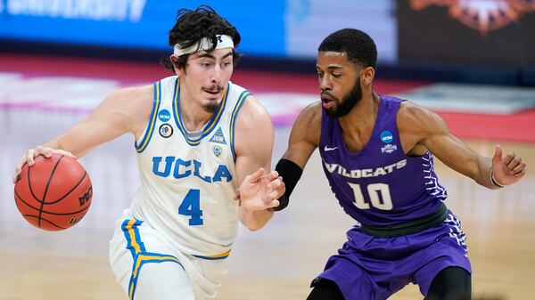 UCLA's Jaime Jaquez Jr. (4) drives against Abilene Christian's Reggie Miller (10) during the first half of a college basketball game in the second round of the NCAA tournament at Bankers Life Fieldhouse in Indianapolis Monday, March 22, 2021. (AP Photo/Mark Humphrey)