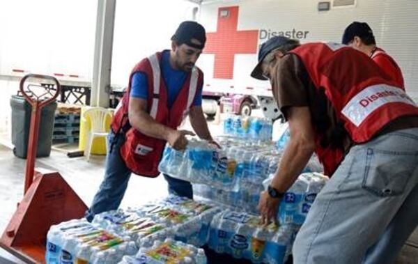 Red Cross volunteers sort supplies and ready water for distribution. (Credit: American Red Cross)