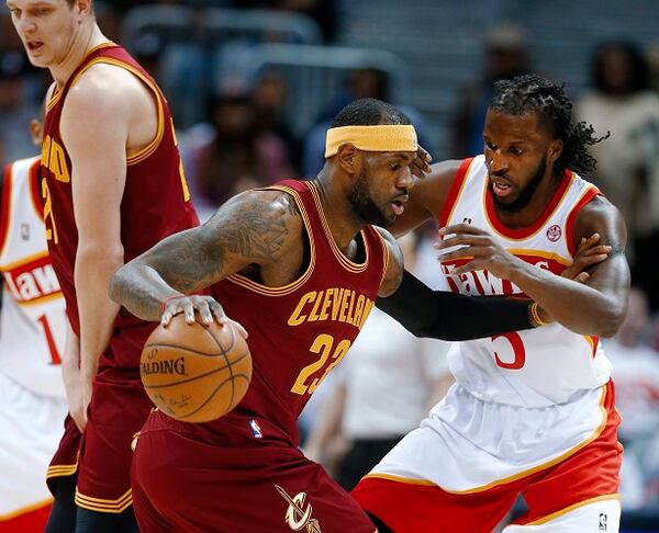 Cleveland Cavaliers forward LeBron James (23) drives against Atlanta Hawks forward DeMarre Carroll (5) during the first half of an NBA basketball game Friday, March 6, 2015, in Atlanta. (AP Photo/John Bazemore) DeMarre Carroll unhorses The King. (AP photo/John Bazemore)