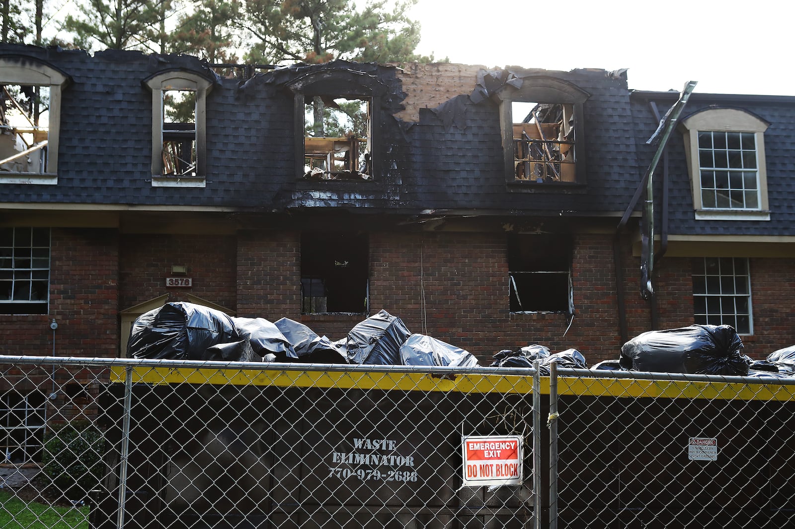 The grounds at The Village at Kensington are blighted by burnt-out apartments, puddles of raw sewage and crumbling balconies.  Local prosecutors have tried for years to get the complex, now called Avondale Village, to make repairs. (Curtis Compton / Curtis.Compton@ajc.com)