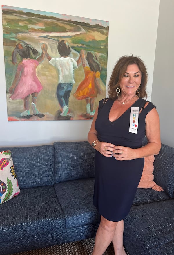 Atlanta artist Lisa Moore stands in front of the artwork she donated to the Children's Bereavement Center in Uvalde, Texas.