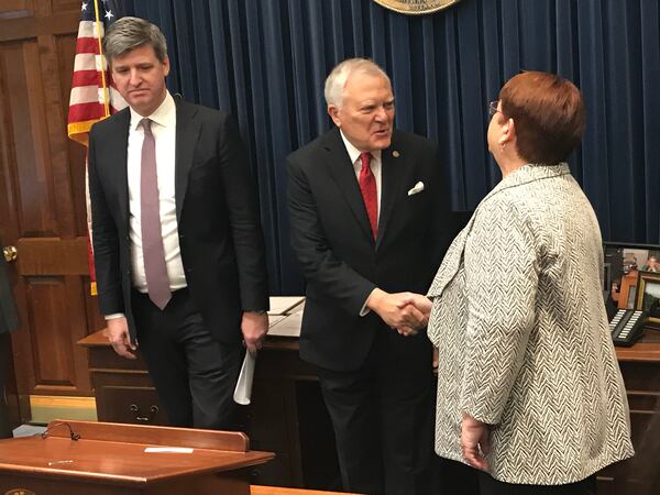 Georgia Gov. Nathan Deal (center) shakes hands with Gwinnett County Commission Chair Charlotte Nash as Uffe Ostergaard, the president of Hapag-Lloyd's North America region, looks on. Hapag-Lloyd announced Tuesday the creation of more than 350 new jobs in Gwinnett. TYLER ESTEP / TYLER.ESTEP@AJC.COM