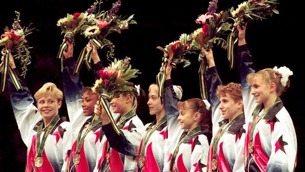 Members of the United States women's gymnastics team - Amanda Borden (from left), Dominique Dawes, Amy Chow, Jaycie Phelps, Dominique Moceanu, Kerri Strug, and Shannon MIller - wave to the crowd after being awarded their gold medals in the team competition of the 1996 Olympic Games Tuesday, July 23, 1996, at the Georgia Dome in Atlanta. (John Gaps III/AP)