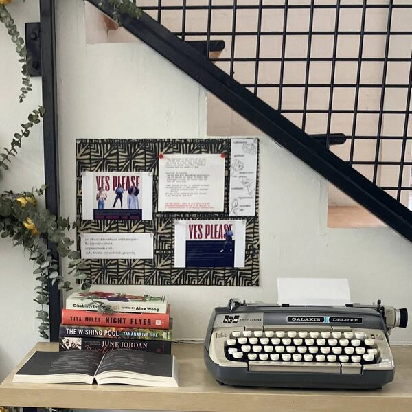 A typewriter and a stack of books at bookstore Yes, Please, located in Scottsdale, Ga.