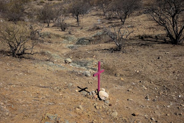 Crosses left by border activists mark the locations where the remains of migrants who died trying to cross into the United States through the harsh conditions of the Sonoran Desert were discovered, in the Altar Valley, Arizona. (ANDREW LICHTENSTEIN/CORBIS/GETTY IMAGES)