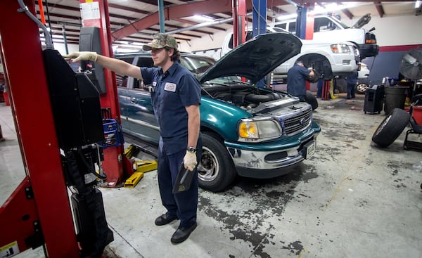 Dustin Monacelli works on a customer’s car at Eddie’s Automotive Service in Lilburn on May 13, 2020. STEVE SCHAEFER / SPECIAL TO THE AJC