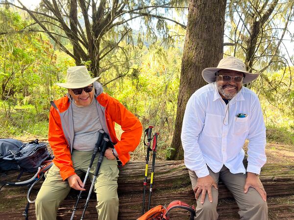 Dr David A. Thomas and C. David Moody take a breather before continuing their hike up Mount Kilimanjaro, which stands at more than 19,000 feet above sea level. (Contributed by C. David Moody Jr.)