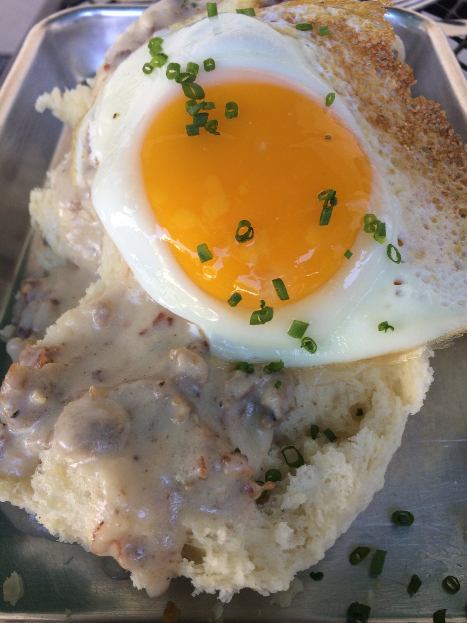 The Little Farmhouse Cafe’s buttermilk biscuits with gravy and sunny side up egg. CONTRIBUTED BY WENDELL BROCK