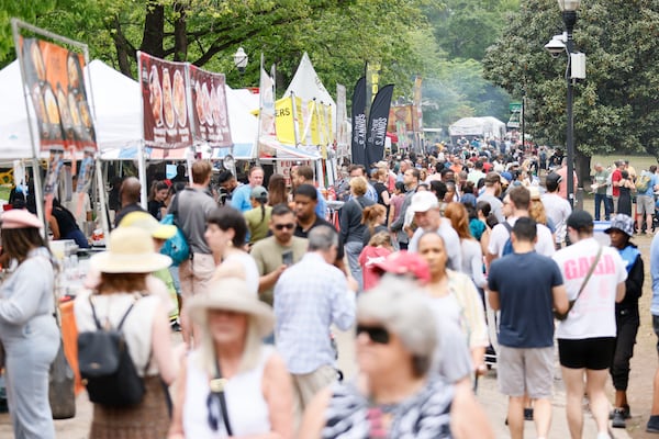 Festivalgoers walk between food vendors during the 87th annual Atlanta Dogwood Festival. This three-day festival features arts and crafts, a kids' area, food, and many games on Sunday, April 16, 2023, in Piedmont Park.
Miguel Martinez /miguel.martinezjimenez@ajc.com