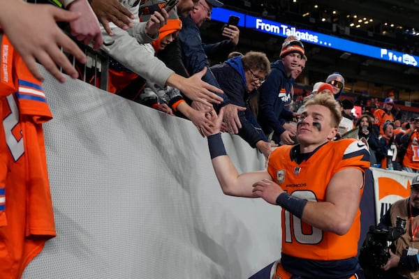 Denver Broncos quarterback Bo Nix (10) celebrates with the crowd after a win over the Atlanta Falcons in an NFL football game Sunday, Nov. 17, 2024, in Denver (AP Photo/Jack Dempsey)