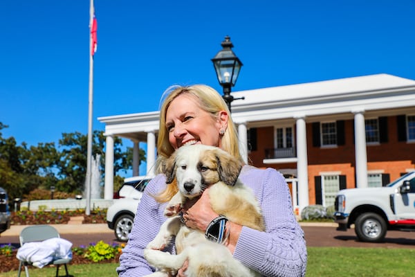 Georgia first lady Marty Kemp holds a dog during the Pet Adoption Day event at the Governor's Mansion last year.