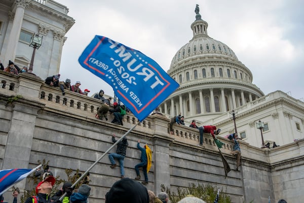 FILE - Support of President Donald Trump climb the West wall of the the U.S. Capitol, Jan. 6, 2021, in Washington. (AP Photo/Jose Luis Magana, File)