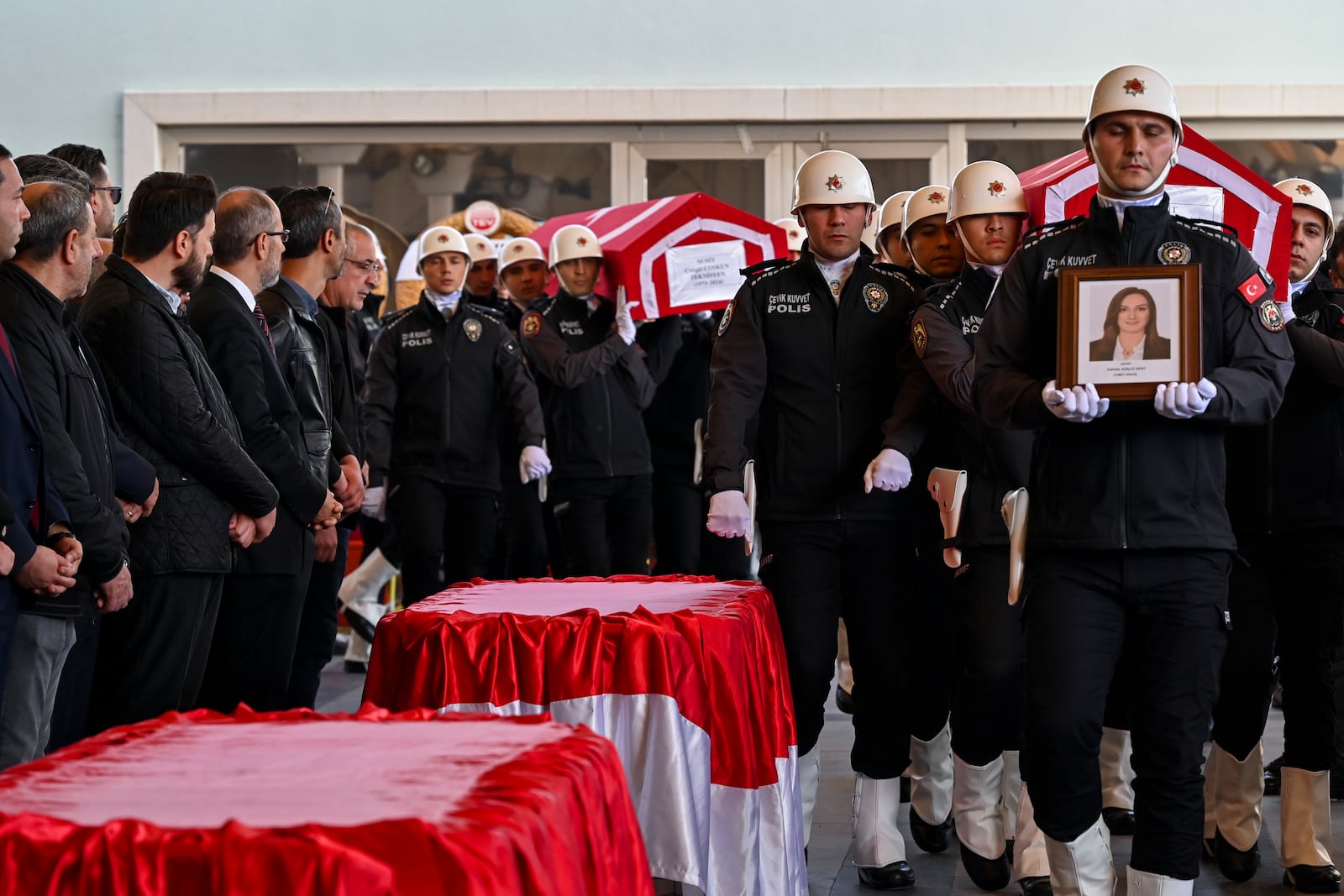 Turkish soldiers carry the coffins of Zahide Guglu Ekici, Hasan Huseyin Canbaz and Cengiz Coskun during their funeral at Karsiyaka mosgue in Ankara, Thursday, Oct. 24, 2024, a day after they were killed during an attack by PKK members at the Turkish aerospace and defense company TUSAS on Wednesday. (AP Photo/Ali Unal)