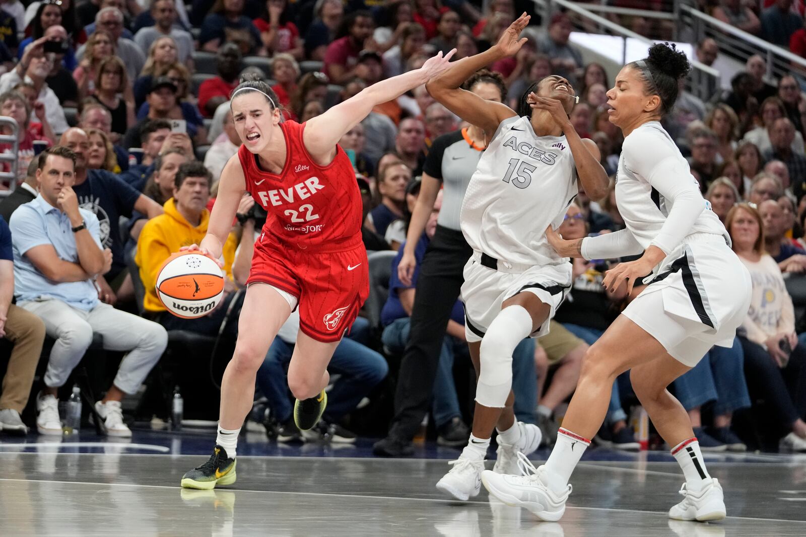 Indiana Fever's Caitlin Clark (22) is called for a foul against Las Vegas Aces' Tiffany Hayes (15) during the first half of a WNBA basketball game, Wednesday, Sept. 11, 2024, in Indianapolis. (AP Photo/Darron Cummings)