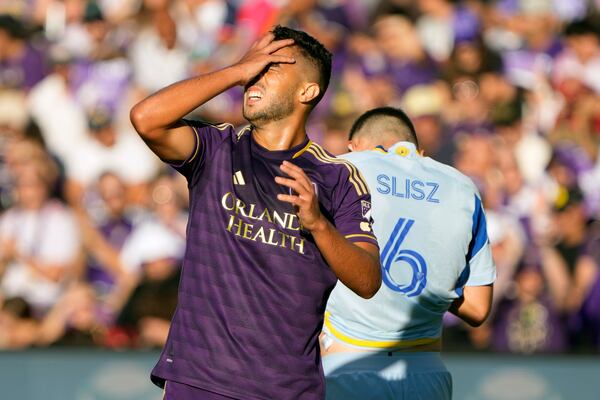 Orlando City's Martin Ojeda, left, reacts after missing a shot on goal against Atlanta United during the first half of an MLS Semifinal Conference playoff soccer match, Sunday, Nov. 24, 2024, in Orlando, Fla. (AP Photo/John Raoux)