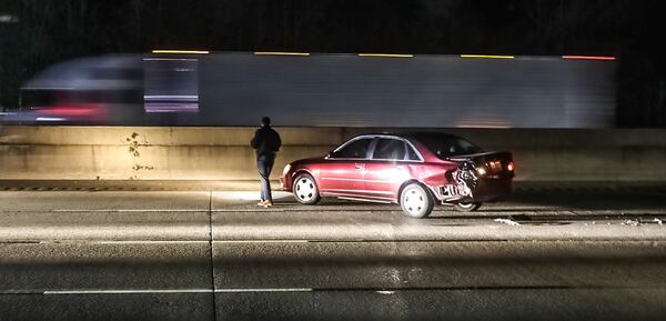 Investigators were focusing on a black SUV and this red sedan with rear-end damage at the shooting scene.