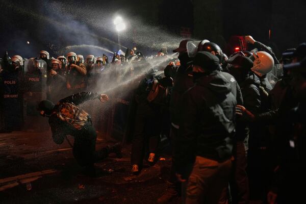 Riot police use pepper spray to clear a protester during a protest against the arrest of Istanbul's Mayor Ekrem Imamoglu, in Istanbul, Turkey, Saturday, March 22, 2025. (AP Photo/Francisco Seco)