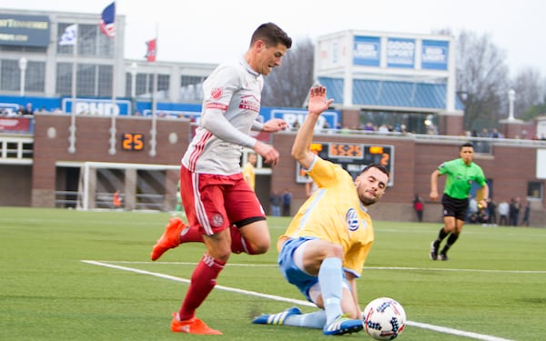 Atlanta United defender Mark Bloom dribbles a Chattanooga defender during he first pre-season match Feb. 11, 2017 in Chattanooga, Tenn.