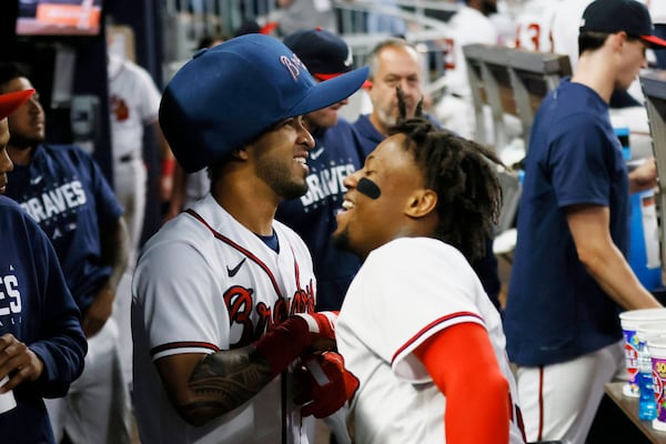 Eddie Rosario (left) wears the big hat after hitting a solo home run during the eighth inning against the Cincinnati Reds on Wednesday, April 12, 2023, at Truist Park in Atlanta. 
Miguel Martinez /miguel.martinezjimenez@ajc.com