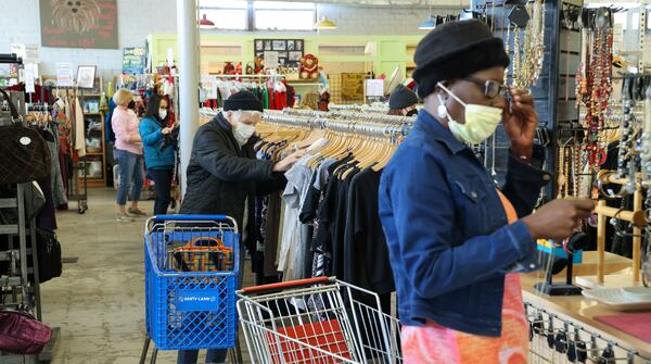 Customers shop at Second Life, an upscale thrift store in Avondale Estates, opened by Toby Tobias and Tanya Mahrous, that supports animal rescue organizations.
 PHIL SKINNER FOR THE ATLANTA JOURNAL-CONSTITUTION