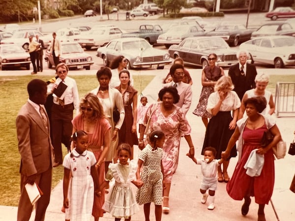 [L to R] Sidney Poitier walks with his family outside Beverly Henderson's college graduation in 1979 with his daughter Anika, his wife Joanna Poitier, his daughter Gina, ex-wife Juanita, granddaughters Kamaria and Aisha Mould, daughter Sydney, Bill Mould, and Frances Jean Walker, journalist Mike Jordan and Constance Jordan.