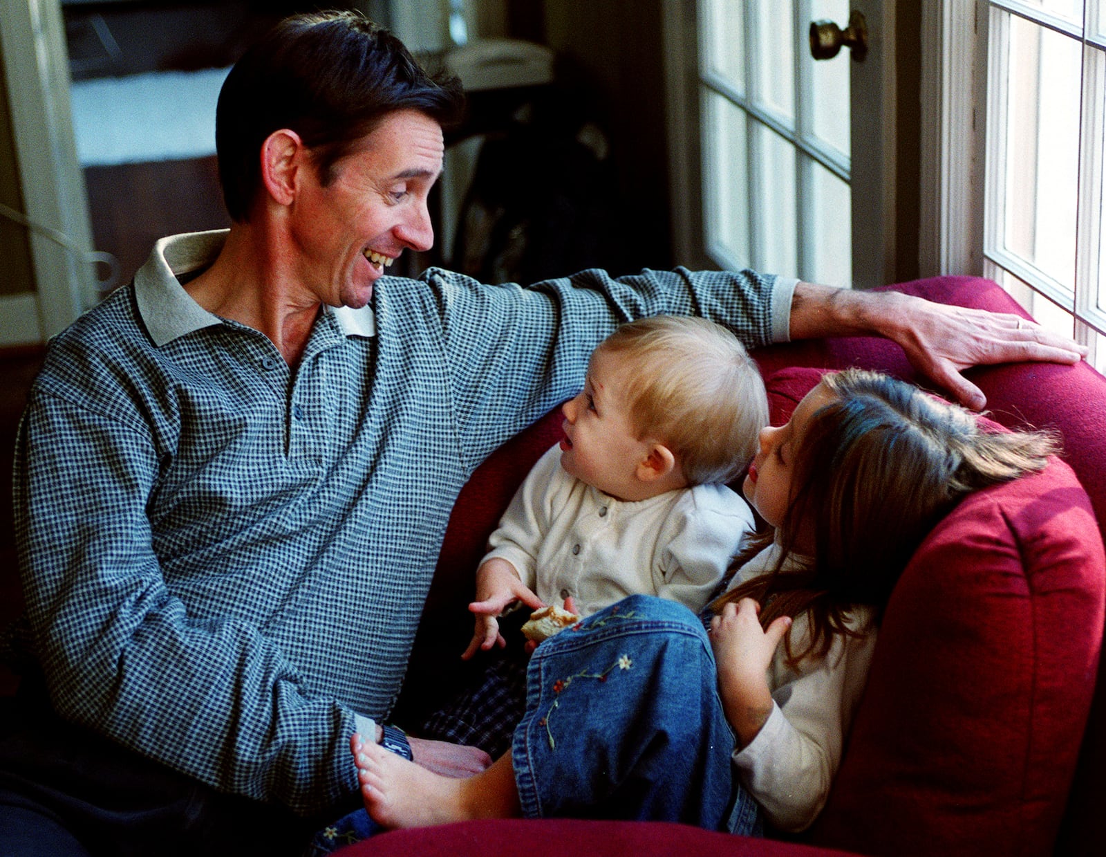 Christopher Rex, ASO's principal cello, plays with with his kids Christopher (then age 15 months) & Caroline (then 5 years old) in their family home. (PHIL SKINNER /staff).