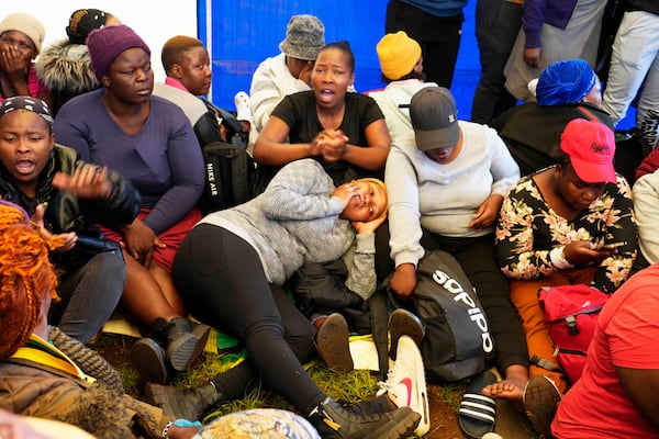 Relatives and friends wait for news near a reformed gold mineshaft where illegal miners are trapped in Stilfontein, South Africa, Friday, Nov. 15, 2024. (AP Photo/Denis Farrell)