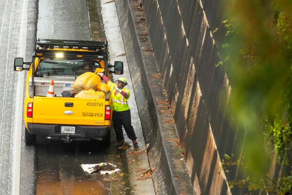 09/16/2020 - Atlanta, Georgia - Georgia Department of Transportation employees clean storm drains along Interstate-75 in anticipation of heavy rains from Hurricane Sally in Atlanta, Wednesday, September 16, 2020. (Alyssa Pointer / Alyssa.Pointer@ajc.com)