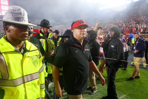 Georgia head coach Kirby Smart is escorted off of the field after Georgia’s loss at Vaught Hemingway Stadium, Saturday, November 9, 2024, in Oxford, Ms. Mississippi won 28-10. (Jason Getz / AJC)
