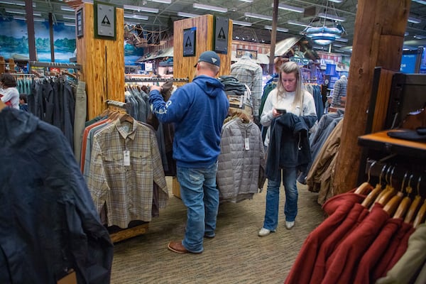 Tatum Phillips and his wife Cheyenne shop for Christmas presents at the Bass Pro Shops near Lawrenceville on Saturday, November 13, 2021. STEVE SCHAEFER FOR THE ATLANTA JOURNAL-CONSTITUTION