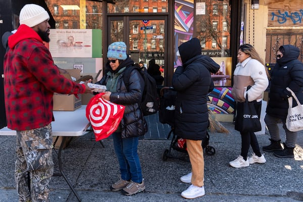 Abou Sow hands out cartons of eggs to people waiting in line to receive free eggs from FarmerJawn Agriculture, Friday, March 21, 2025, in the Harlem neighborhood of New York. (AP Photo/Julia Demaree Nikhinson)