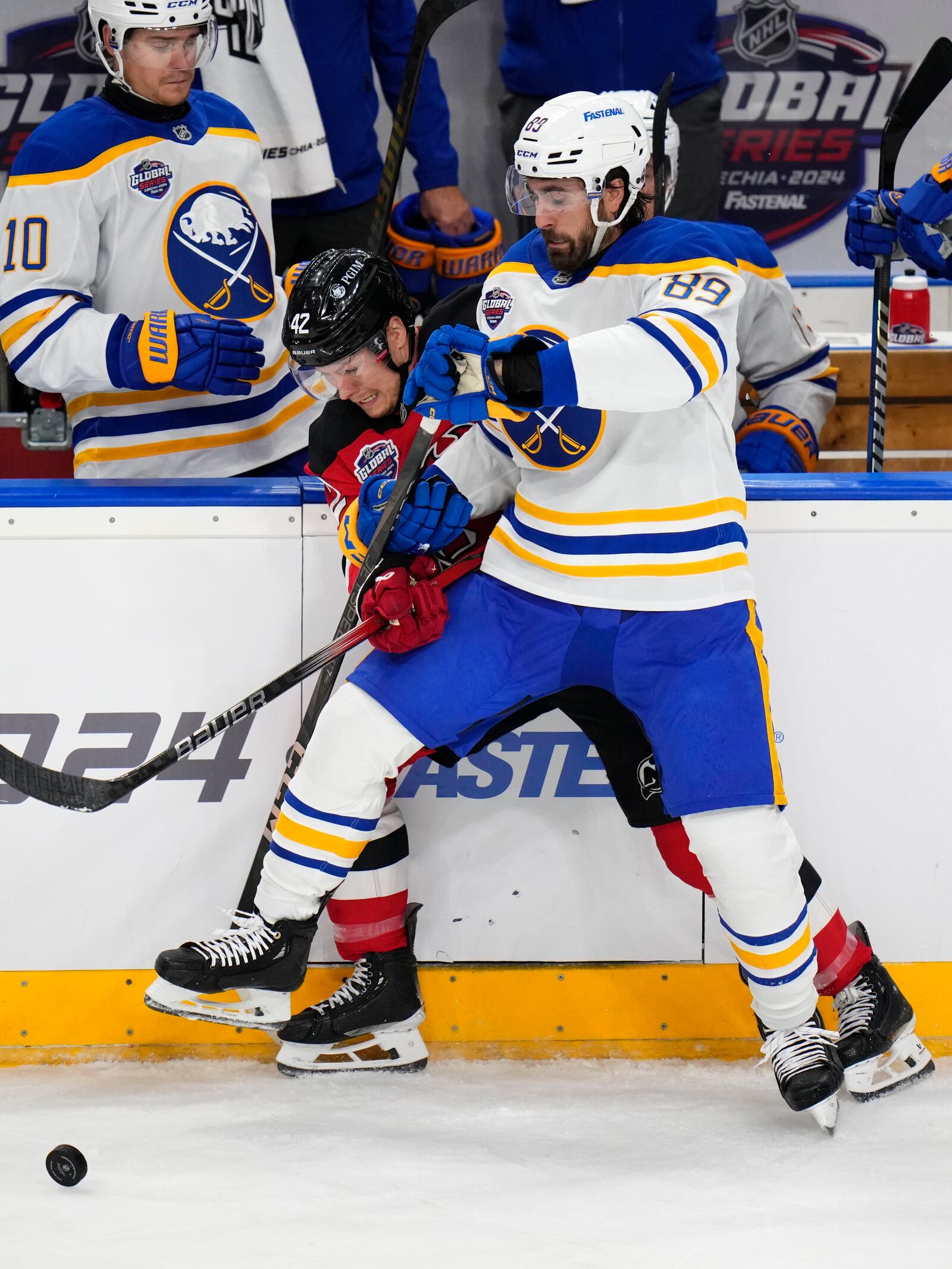 Buffalo Sabres' Alex Tuch, right, challenges New Jersey Devils' Curtis Lazar during the NHL hockey game between Buffalo Sabres and New Jersey Devils, in Prague, Czech Republic, Saturday, Oct. 5, 2024. (AP Photo/Petr David Josek)