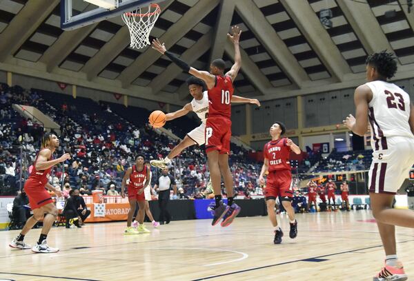 Cross Creek's Devin Pope (0) gets off a pass around Sandy Creek's Jabari Smith (10) during the Class 3A boys championship game Friday, March 12, 2021, in Macon. (Hyosub Shin / Hyosub.Shin@ajc.com)