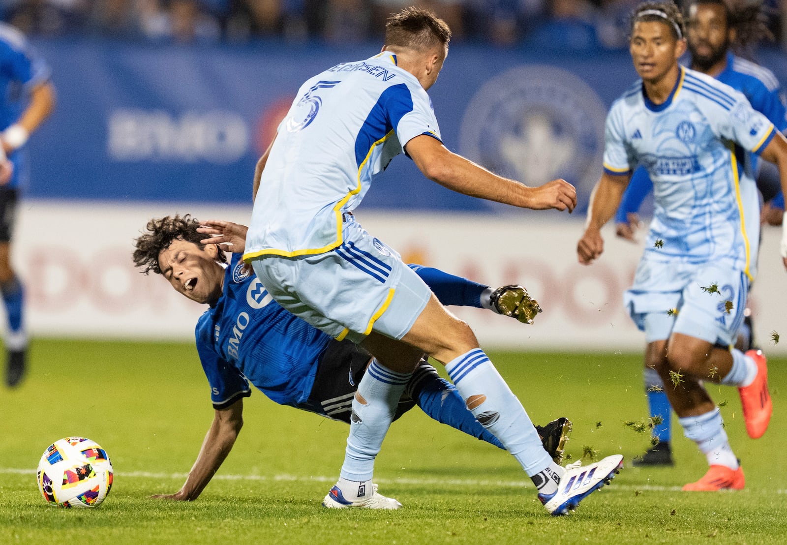 CF Montreal midfielder Caden Clark, left, is challenged by Atlanta United defender Stian Gregersen (5) during the first half of an MLS playoff soccer game in Montreal, Tuesday, Oct. 22, 2024. (Christinne Muschi/The Canadian Press via AP)